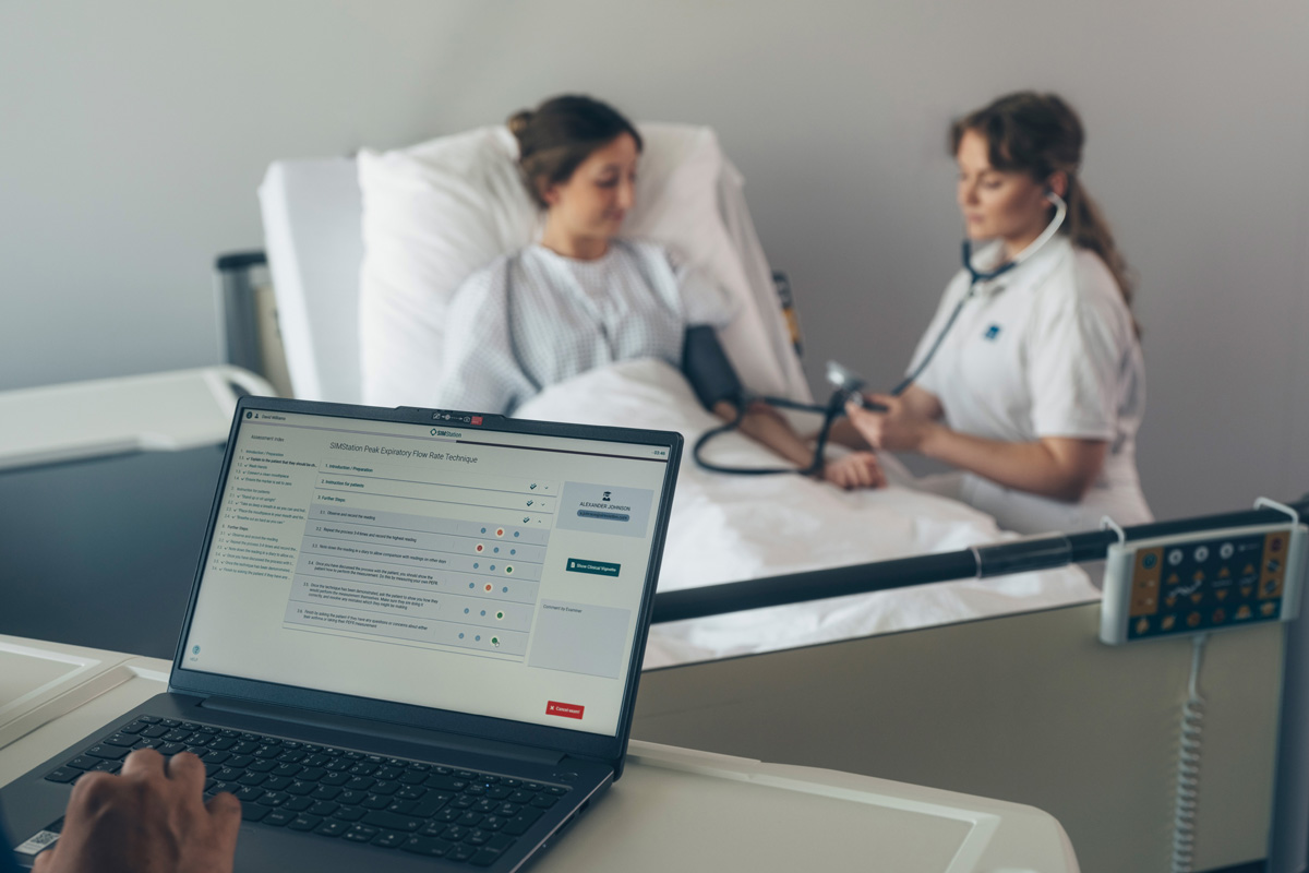 Two students during an OSCE exam, with performance being evaluated in real time.