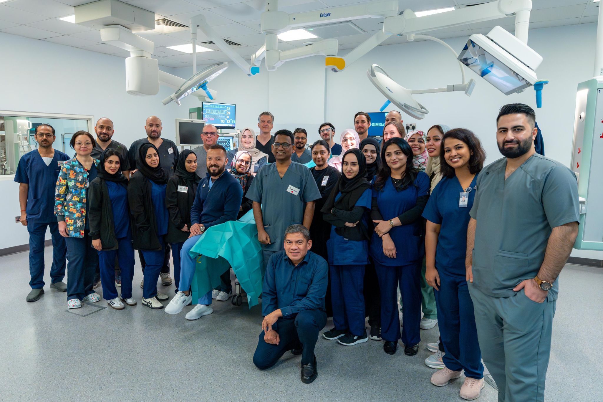 Group of healthcare professionals in a clinical simulation lab, standing together in a modern medical training environment
