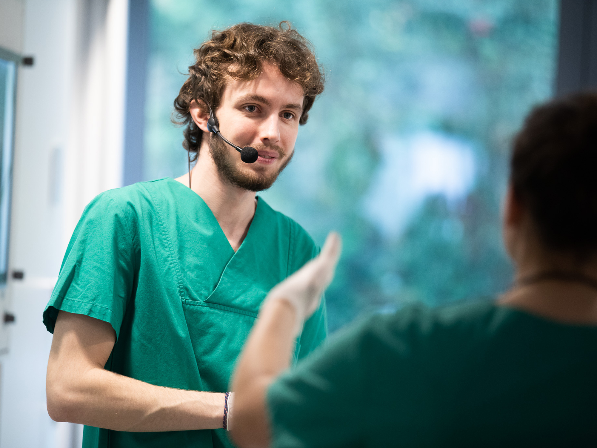 Simulation participant wearing radio microphone during a training scenario.