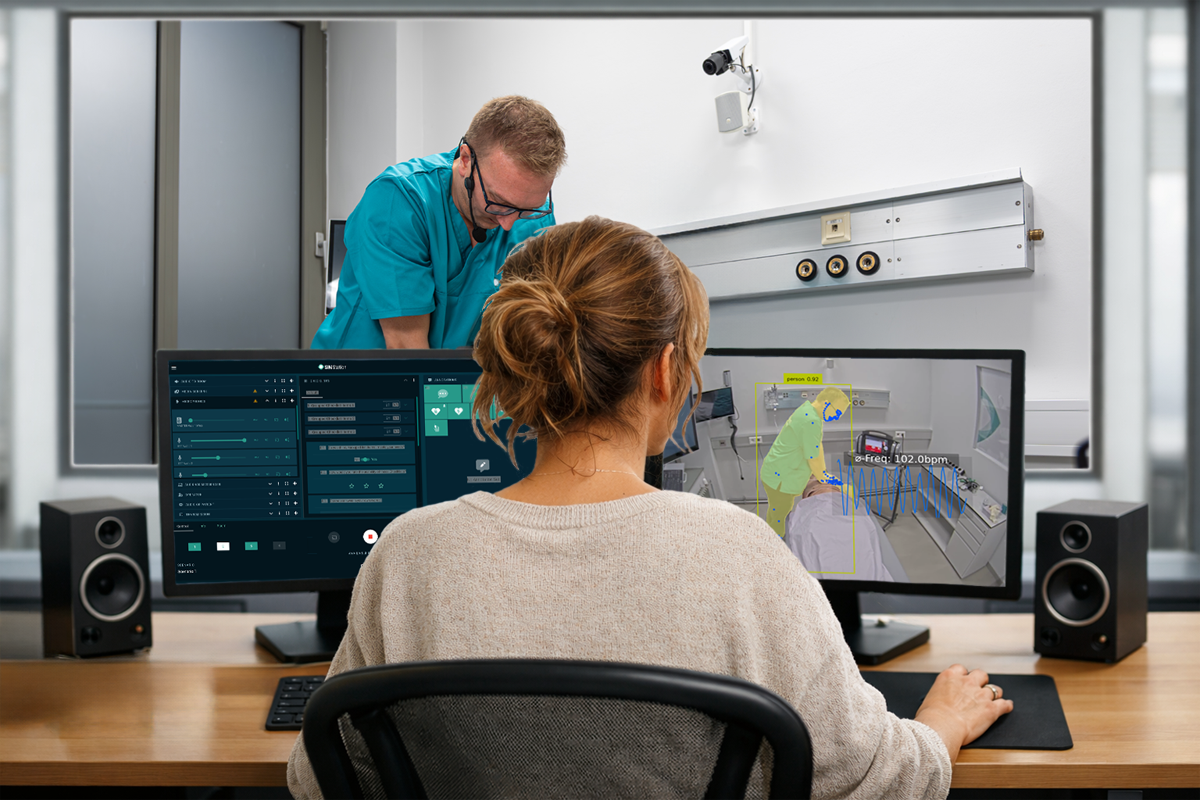Simulation instructor monitoring training performance and real-time data on a dual-screen control interface